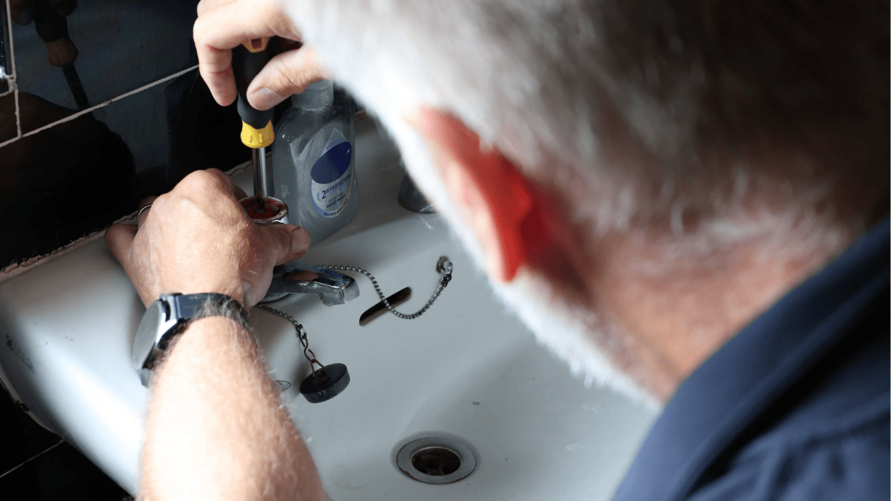 Plumber fixing a tap