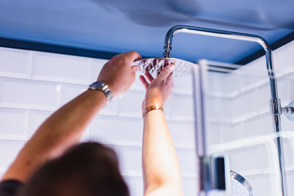 a man fitting a water saving device